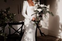 21 a modern plain mermaid wedding dress with a square neck, long sleeves with accented shoulders, a sash and a train is gorgeous for a modern wedding