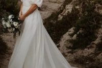 24 a modern wedding ballgown with a draped bodice and a square neckline, puff sleeves, a long veil and a long train for a romantic look