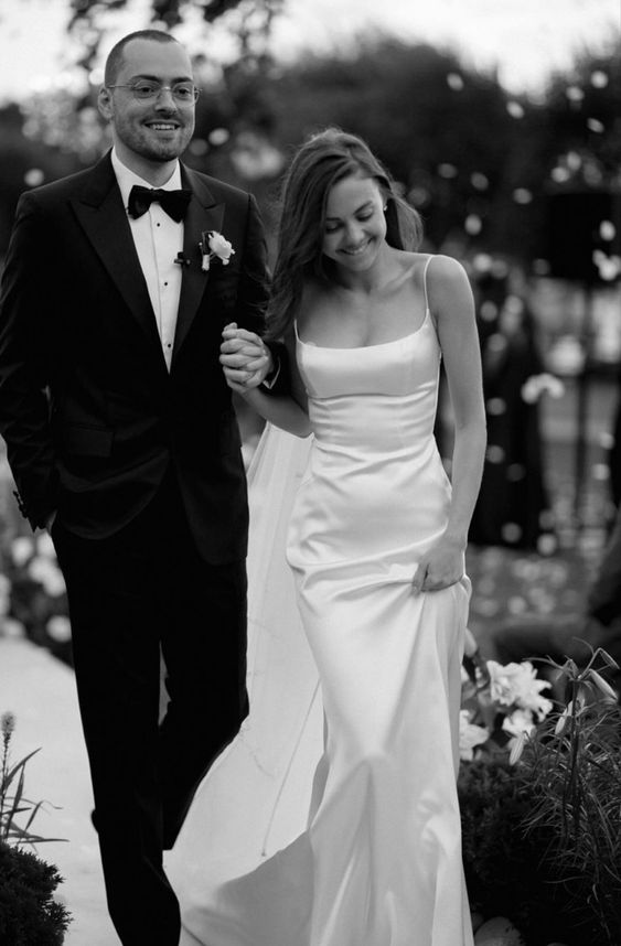 a sophisticated modern plain mermaid wedding dress with a square neckline and spaghetti straps plus a long train for a modern refined wedding