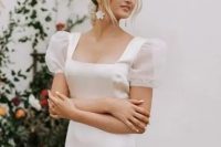 33 an elegant wedding dress with a square neckline and sheer puff sleeves for a feminine and chic look and flower earrings that accent the look