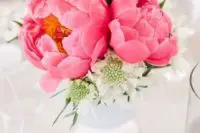 a beautiful and very simple wedding centerpiece of a blush and bold pink peonies and some white blooms is amazing for spring or summer