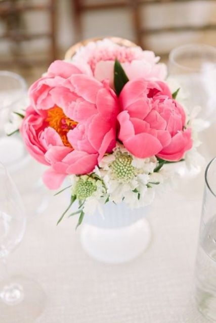a beautiful and very simple wedding centerpiece of a blush and bold pink peonies and some white blooms is amazing for spring or summer