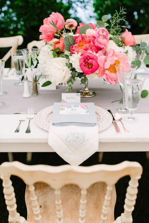 a bold and refined wedding centerpiece of white, pink and fuchsia peonies and ranunculus and greenery is amazing for summer
