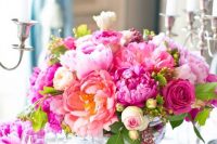 a bright wedding centerpiece of hot pink, fuchsia, blush blooms including roses and peonies is a bold solution for a summer wedding