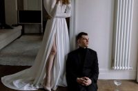 a chic modern plain wedding dress with puff sleeves, a plunging neckline, a thigh high slit and a train is a gorgeous idea for a Parisian wedding