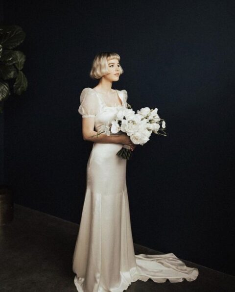 a dreamy vintage-inspired bridal look with a silk mermaid dress, sheer puff sleeves and a train is a creative out of the box idea