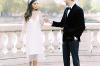 a pretty and out of the box wedding dress wiht a slip knee underdress, a sheer midi overdress with long sleeves, white shoes and a headband