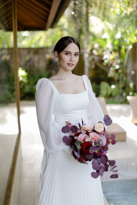 a romantic wedding dress with a square neckline, puff sleeves and a pleated skirt is a beautiful idea to go for