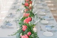 a stylish wedding table runner of greenery and bold pink peonies is a lovely summer wedding decor idea to rock
