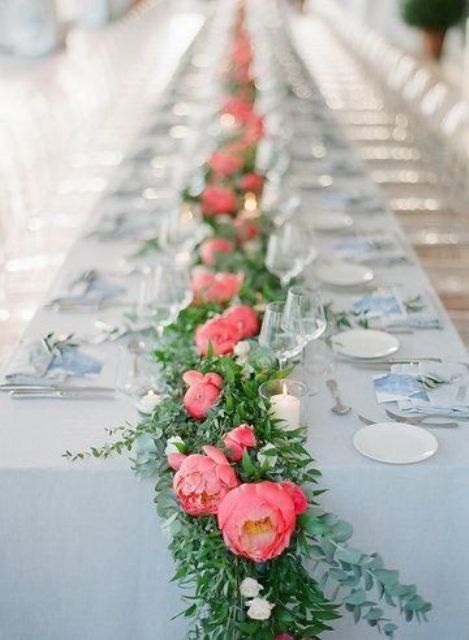 a stylish wedding table runner of greenery and bold pink peonies is a lovely summer wedding decor idea to rock