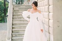 a wedding ballgown with off the shoulder puff sleeves, spaghetti straps and a train is adorable and comfy to wear