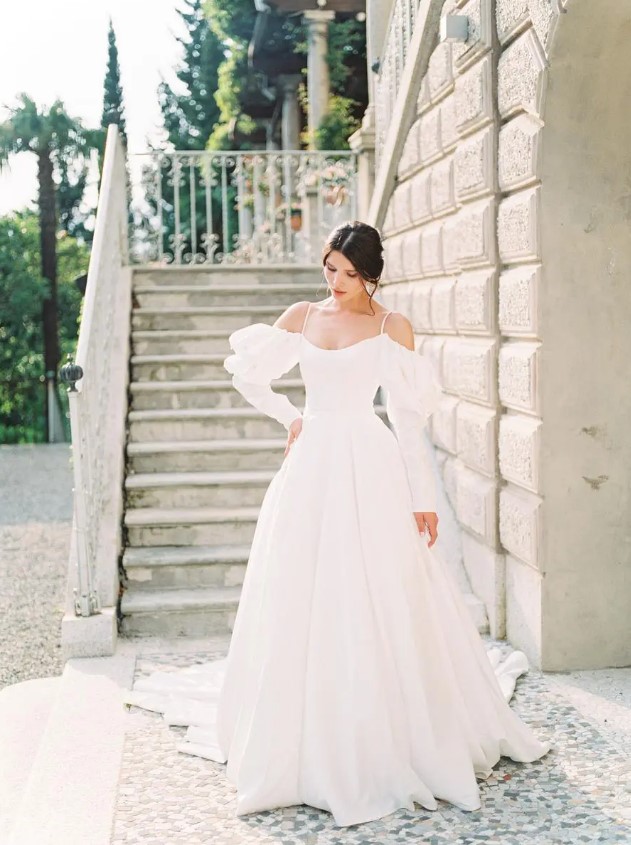 a wedding ballgown with off the shoulder puff sleeves, spaghetti straps and a train is adorable and comfy to wear