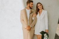 a white blazer mini dress with long sleeves, black ankle strap shoes and a catchy orchid bouquet for an effortlessly chic look