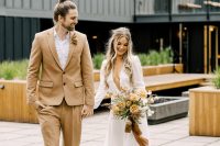 03 a minimalist bridal look with a plain wedding dress, a plunging neckline and puff sleeves, a groom wearing a beige suit, beige shoes and a white shirt
