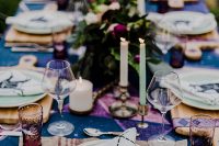 04 a bold boho rock n roll wedding tablescape done in purple and blue, with purple and blush blooms, neutral and mint green candles and plates