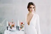 04 a minimalist bridal look with a plain plunging neckline wedding dress, long sleeves is a chic and cool idea for a fall wedding