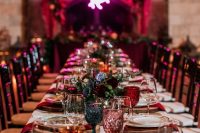 05 a bold rock n roll wedding table setting with jewel-tone glasses, red napkins, printed plates and deep colored blooms
