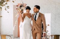 09 minimalist couple’s looks with a rust suit and white sneakers, a white slip maxi wedding dress with a train for the fall