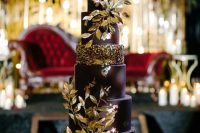 11 a deep purple wedding cake with gold blooms and gilded foliage is a fantastic idea for a fall wedding