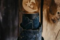 a jaw-dropping navy and midnight blue celestial wedding cake with a raw edge and gold touches plus a moon holding the upper tier