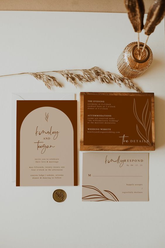 a chic minimalist invitation suite with burgundy and neutral parts, with calligraphy and modern lettering and botanical prints