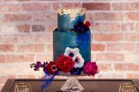 16 a navy wedding cake with a textural edge and gold leaf on top, with bold blooms and foliage is a lovely idea for a fall wedding