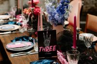 18 a super bold and cool rock n roll wedding tablescape with pink and blue blooms, hot pink, black and blush candles, a pink sequin runner and teal napkins