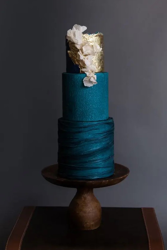 a sophisticated navy blue wedding cake with textural tiers, gold leaf and blush blooms is a very chic and very stylish idea for a modern wedding