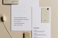 20 a stylish contemporary to minimalist wedding invitation suite in white and tan, with stylish black letters and letter pressing is chic