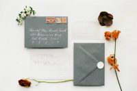 21 a stylish minimalist fall wedding invitation suite in graphite grey and white, with calligraphy and cool lettering