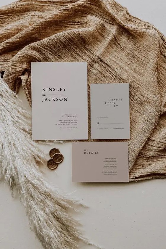 an elegant neutral colored minimalist wedding invitation suite in light grey and dusty pink, with black lettering is a cool idea