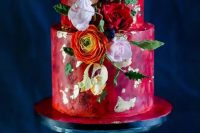 23 a bright red watercolor wedding cake with gold leaf, orange, pink and red blooms, leaves and berries is a gorgeous idea for a bold and colorful wedding