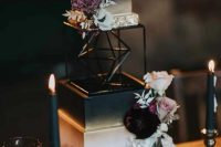 30 a gorgeous glam rock wedding cake of several parts, with white and deep purple blooms and white foliage is wow