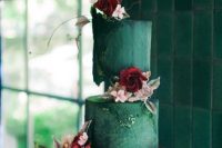 33 a gorgeous and bold wedding cake with green and red tiers, gold detailing, blush and deep red blooms and greenery