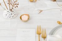 33 a minimalist neutral wedding table setting with white linens, grey plates and chargers, candles, gold cutlery and dried blooms