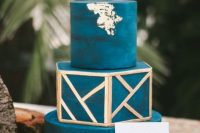 38 a teal wedding cake with gold geometric detailing and gold leaf is a lovely idea for a bold fall wedding
