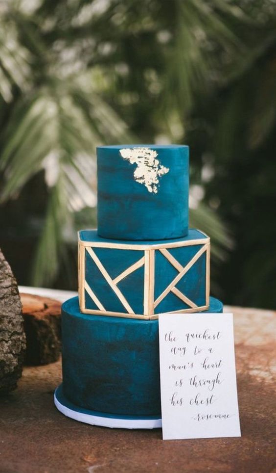 a teal wedding cake with gold geometric detailing and gold leaf is a lovely idea for a bold fall wedding