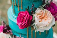 40 a turquoise naked wedding cake decorated with fresh blush, hot pink and deep purple blooms, greenery and gold drip inspires and excites