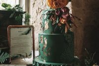 43 an emerald wedding cake with a textural tier, green sugar blooms, gold leaf and bold natural and sugar blooms on top