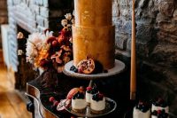 48 a decadent wedding cake in rust shades, with a texture and gold leaf plus fresh fruit and berries around and on top is perfect for a fall wedding