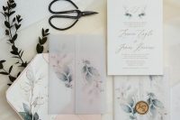 a beautiful and chic botanical wedding invitation suite with gold calligraphy, botanical prints, a vellum jacket and a blush envelope