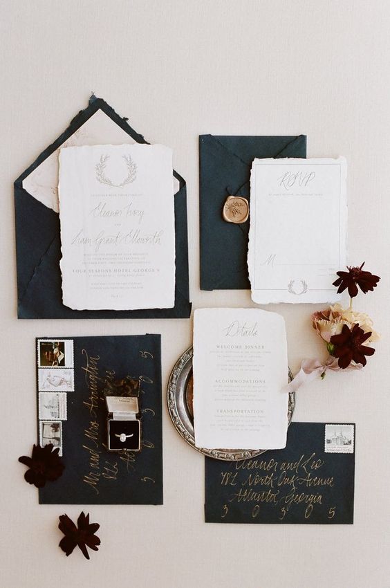 a black and white wedding invitation suite of handmade paper, calligraphy and gold seals is a lovely idea for a refined wedding