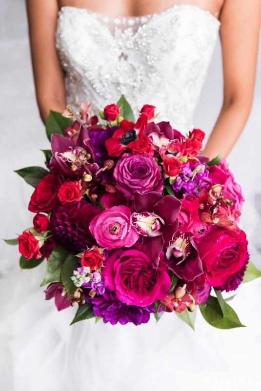 a bold jewel tone wedding bouquet of hot pink, purple, deep purple and deep red blooms and foliage is wow for the fall