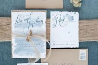 a chic beach wedding invitation with kraft envelopes, light blue wedding invites with watercolors and elegant blue calligraphy