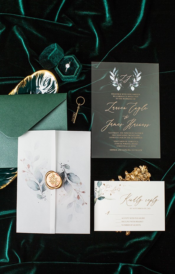 a chic fall wedding invitation suite with an emerald envelope, an acrylic and usual paper invitation with botanical prints and a vellum jacket with a seal