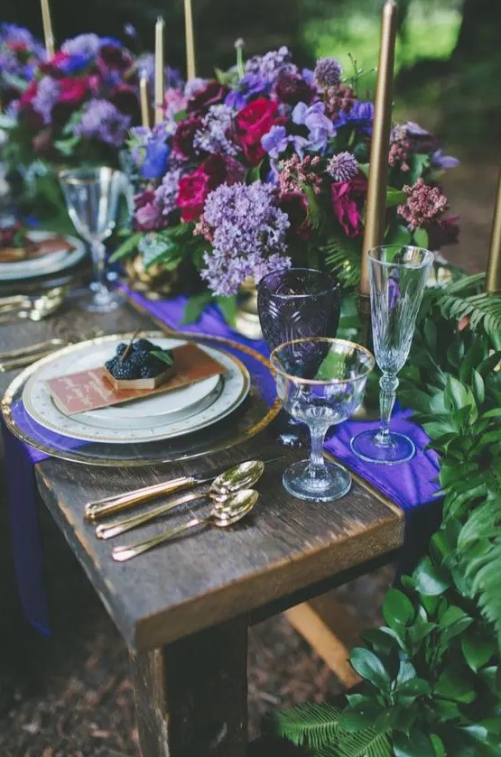 a chic lilac, purple, blue and fuchsia floral centerpieces are amazing for a bold jewel tone wedding tablescape