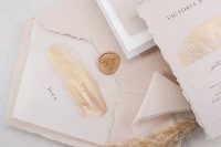 a delicate blush wedding invitation suite with a torn edge, with watercolors and gold, with seals and modern lettering