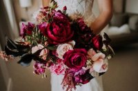 a gorgeous jewel tone wedding bouquet with fuchsia, burgundy, blush blooms, foliage and amaranthus for the fall