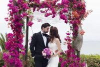 a hot pink bougainvillea wedding arch brings a real wow factor to the wedding, and this shade will strike everyone