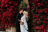a jaw-dropping wedding arch of living deep red blooms growing here is a fantastic solution for a refined and lush fall wedding